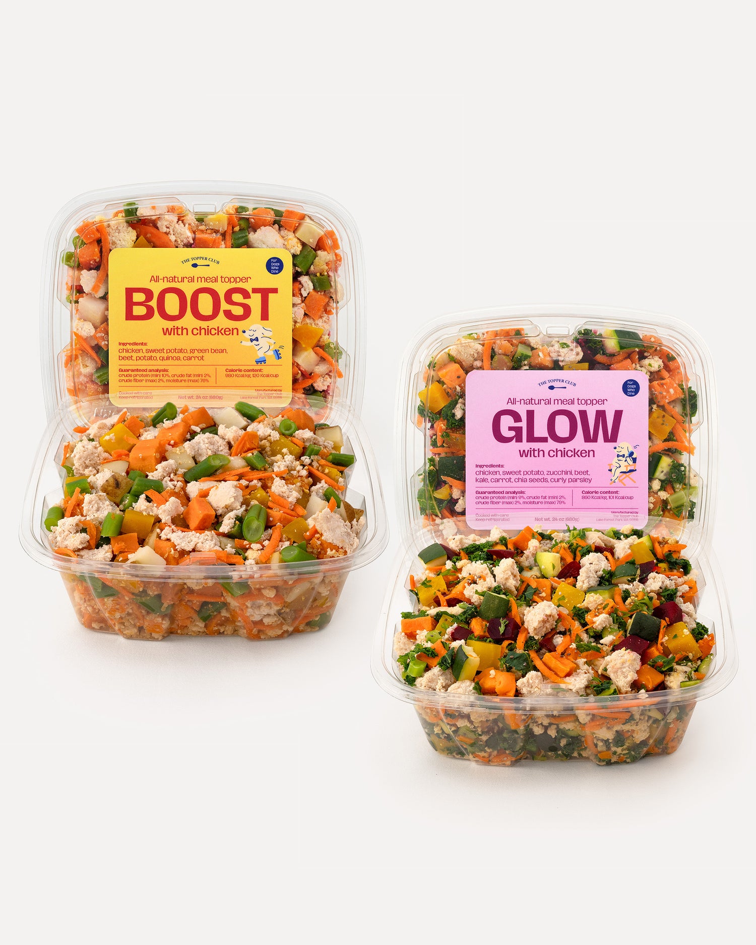 Two containers of dog food topper from The Topper Club with visible labels on a white background
